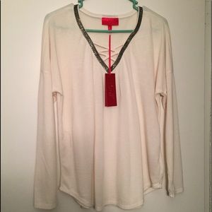 Jennifer Lopez v-neck studded/crisscross sweater.